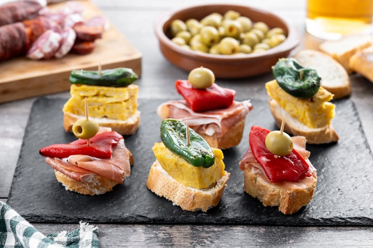 Traditional Spanish pintxos on wooden table